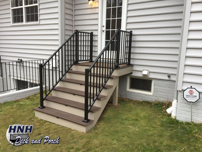 Trex Transcend steps using Spiced Rum for the landing and Vintage Lantern steps with i-Lighting accent lights and Westbury black aluminum railing.