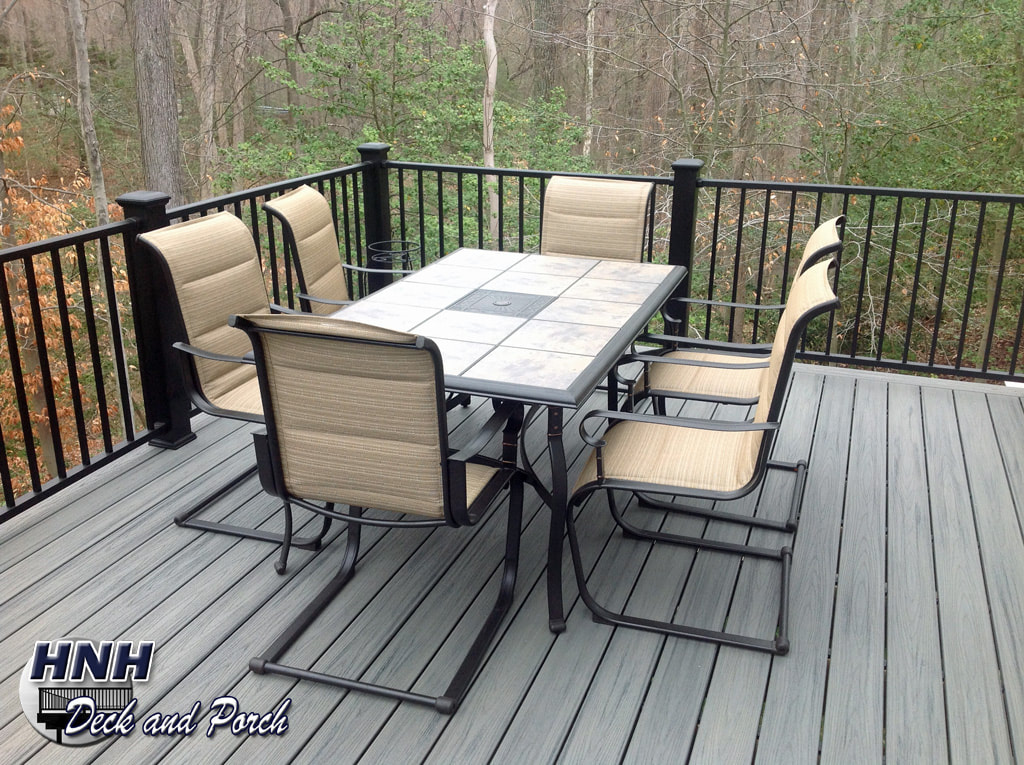 Trex Transcend composite deck using Island Mist flooring and Westbury aluminum railing and balusters with black composite posts.