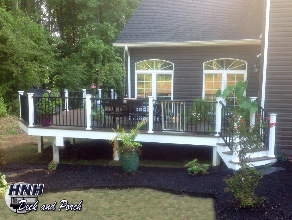 Trex Transcend composite deck using Spiced Rum flooring and Westbury aluminum railing and balusters with white composite posts.
