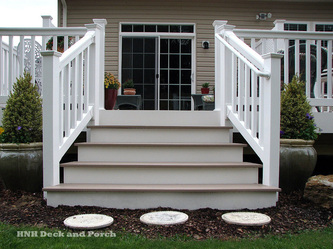 Vinyl deck with Flared steps using Azek Brownstone decking and Longevity white PVC railing.