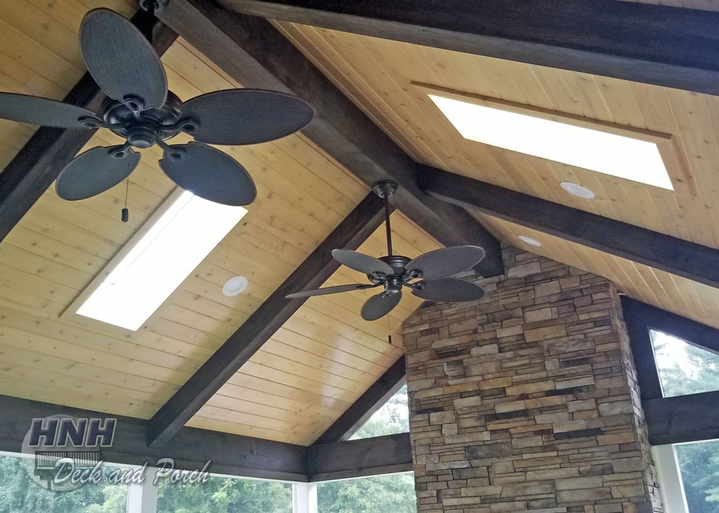 Screened porch with a stained cedar ceiling and skylights