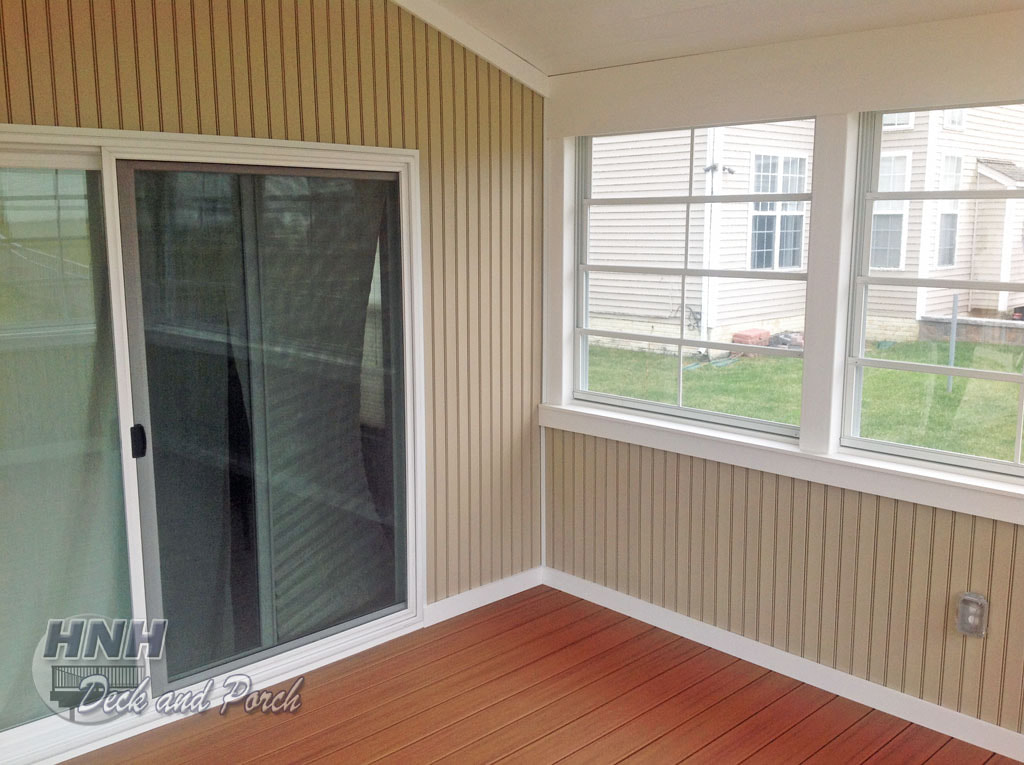 3 Season room with vinyl bead board knee wall in wicker and vaulted ceiling