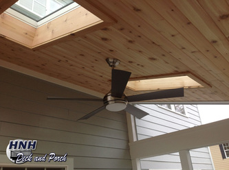 Low maintenance porch with cedar ceiling and sky lights.