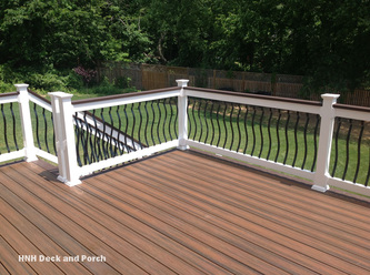 Transcend Decking with Spiced Rum flooring and Vintage Lantern border and cap rail with black brogue aluminum balusters.