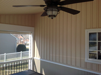 Two-tone vinyl board and batten in Sandtone and Wicker colored siding with chair rail.