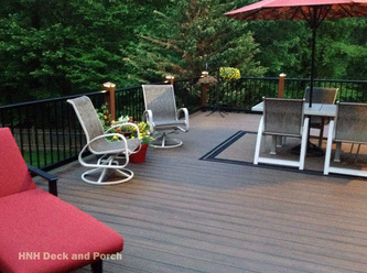 Composite deck using Trex Transcend Decking with Spiced Rum flooring, Tree House posts, and Superior Plastic black railing and balusters.