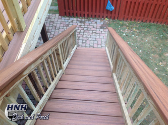 Composite deck with a straight staircase using Trex Transcend Decking with Tiki Torch flooring and cap rail and pressure treated wood railing.