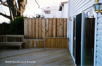ACQ pressure treated pine wood deck with privacy panel, flower boxes, and bench.