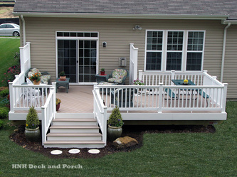 Vinyl deck using Azek Harvest Collection Decking with Brownstone decking and Longevity white PVC railing.