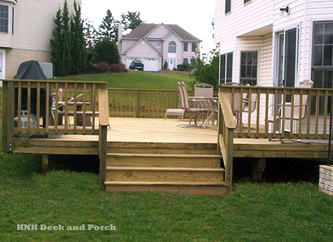 ACQ pressure treated pine wood deck with wide steps.