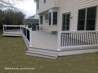 Vinyl patio deck with wide steps using Azek PVC Decking Slat Grey flooring.