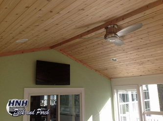 Screened porch with A roof, vaulted, tongue and groove cedar ceiling, recessed lighting, and Eze-Breeze panels.