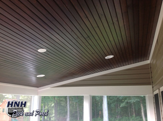 Screened porch with stained pine ceiling and recessed lights.