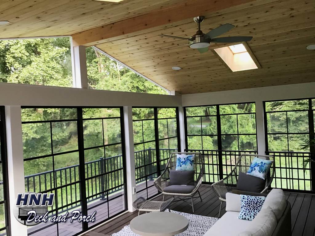 Low maintenance porch using WeatherMaster black sliding panels window system by Sunspace.