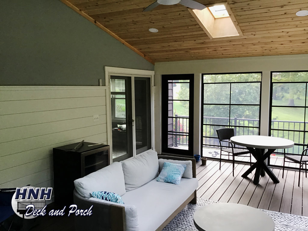 Low maintenance porch with shiplap siding on the house wall.