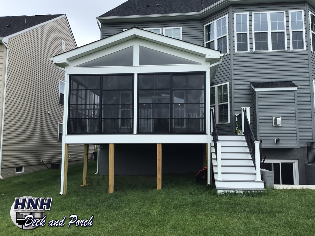 Porch with black framed WeaterMaster panels and black Westbury aluminum railing.